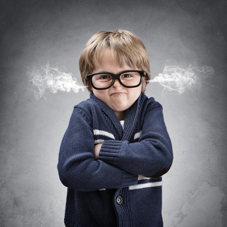 Upset and angry boy with steam coming from his ears and arms fol